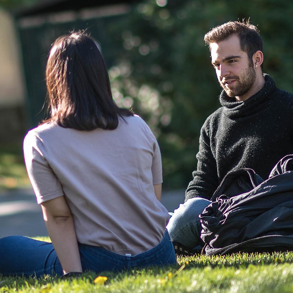 Students sitting on the grass at UBCO campus