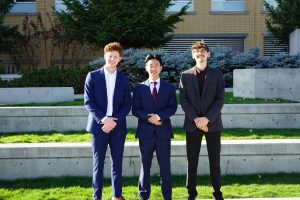 Justin poses with his MGMT friends on the steps of the EME building at UBCO. He and his friends are all dressed up in suits