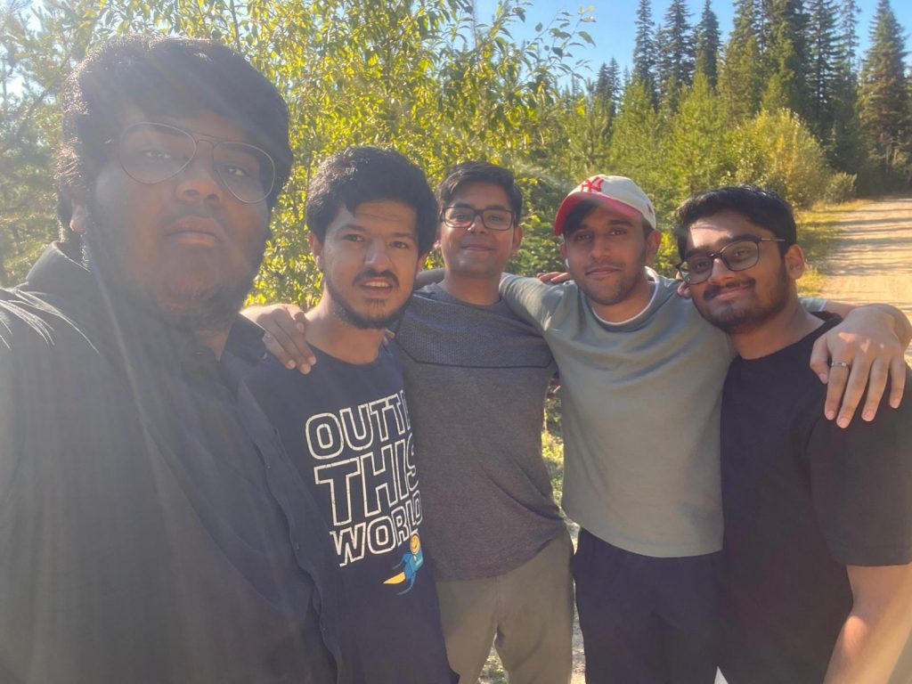 Kanish and friends pose in front of trees